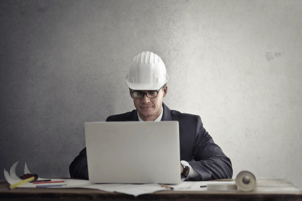 Engineer Working with Laptop at Table